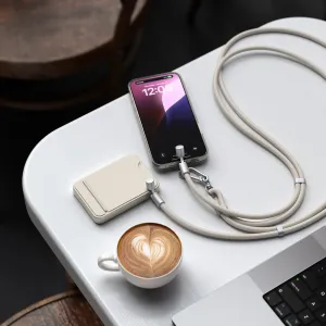 Satechi OntheGo flätad USB-C-kabel med halsrem i sand, ansluten till en smarttelefon med matchande klämma