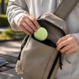 Satechi OntheGo 5-in-1 USB-C adapteris Citrus krāsā, attēlots kā kompakts ceļošanai gatavs disks somā