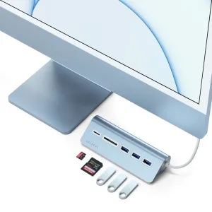 Satechi USB-C aluminum USB hub and card reader in light blue, shown with memory cards and USB drives