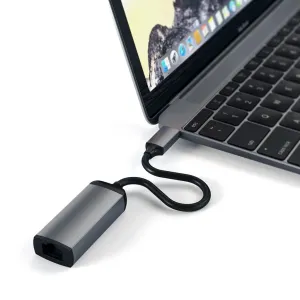 Satechi USB-C–Gigabit Ethernet -sovitin liitettynä kannettavaan tietokoneeseen, kompaktilla tähtiharmaalla alumiinimuotoilulla.