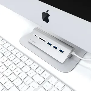 Satechi USB-C -liitännällä varustettu alumiininen USB-keskitin ja kortinlukija työpöydällä Apple-näppäimistön ja näyttötelineen vieressä