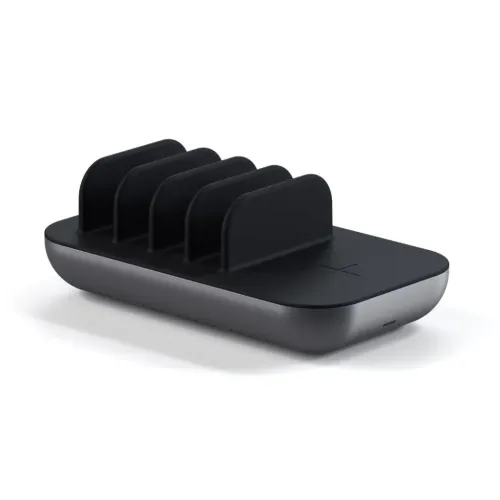 Satechi Dock5 charging station with four black compartments, X-marked surface for wireless charging and rounded edges in black/grey on an exposed white background.