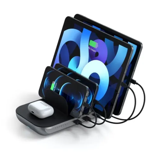Satechi Dock5 charging station with slots, two tablets and two phones via cable and headphone case on wireless plate on the base.