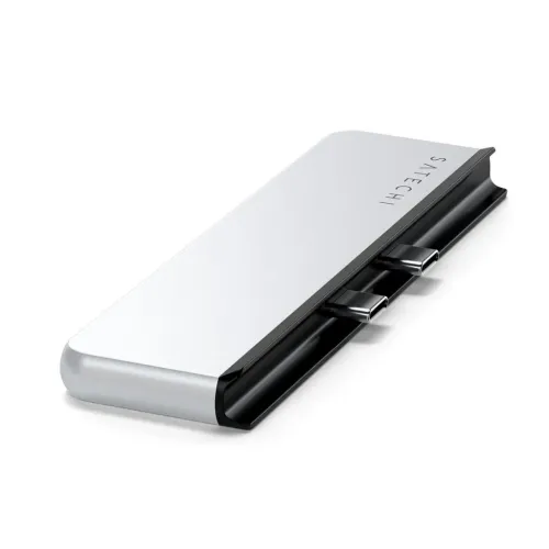 Satechi Dual USB-C Hub in silver, smooth, with rounded corner, black underside and two protruding USB-C connectors at an angle.