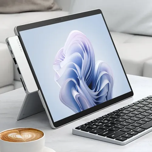 Satechi Dual USB-C hub in silver attached to the left side of tablet with kickstand, with visible USB-A, HDMI and card slots