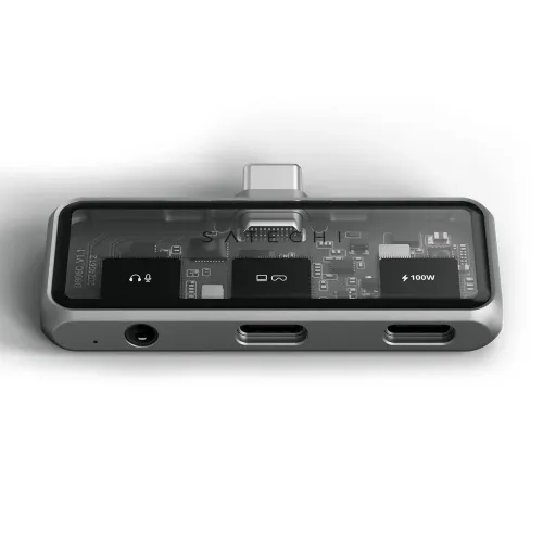 Compact XR hub in space gray with visible circuitry under glass, USB-C connector on top and front with 3.5 mm jack and two USB-C ports.