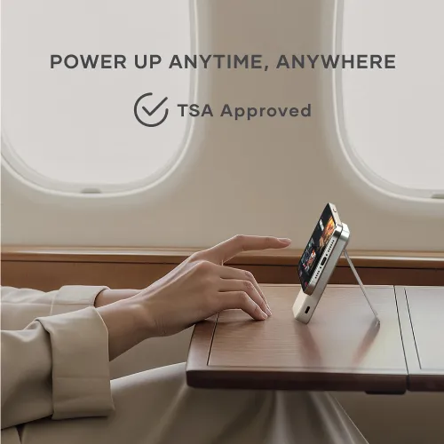 Satechi OntheGo Qi2 magnetic power bank with stand holding a phone upright for portable wireless charging