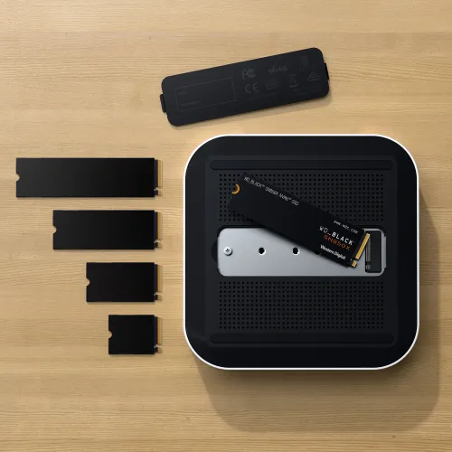 Satechi Thunderbolt 5 CubeDock with SSD enclosure, shown with NVMe SSD modules on a wood surface