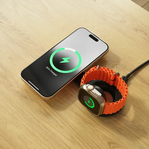 Satechi OntheGo 2-in-1 wireless charger with iPhone and Apple Watch on a tabletop, charging with cable attached